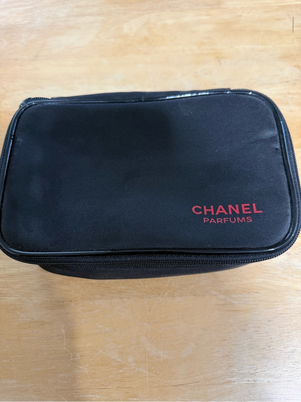 CHANEL Black Cosmetic Pouch with Red Logo
